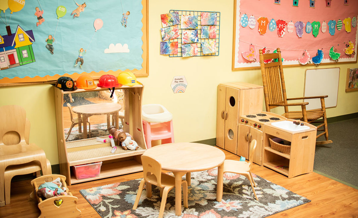 Student playroom with tables and bookshelves