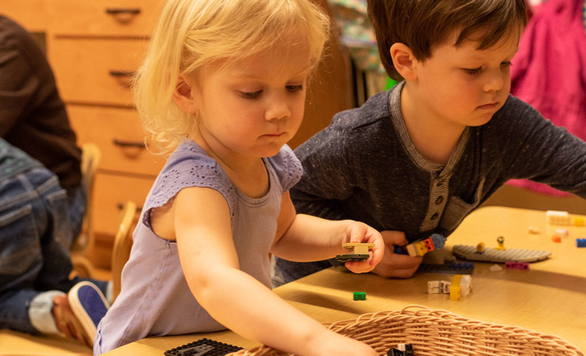 Toddler boy ad girl playing with Legos together