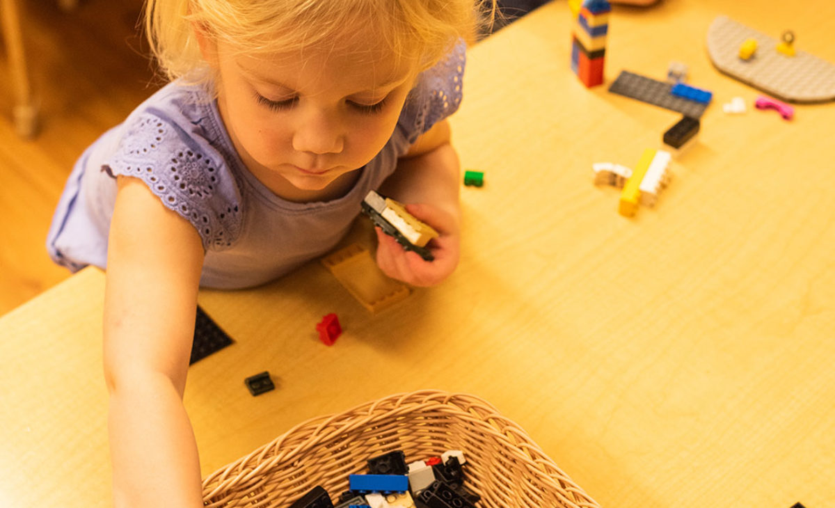 Toddler girl playing with legos