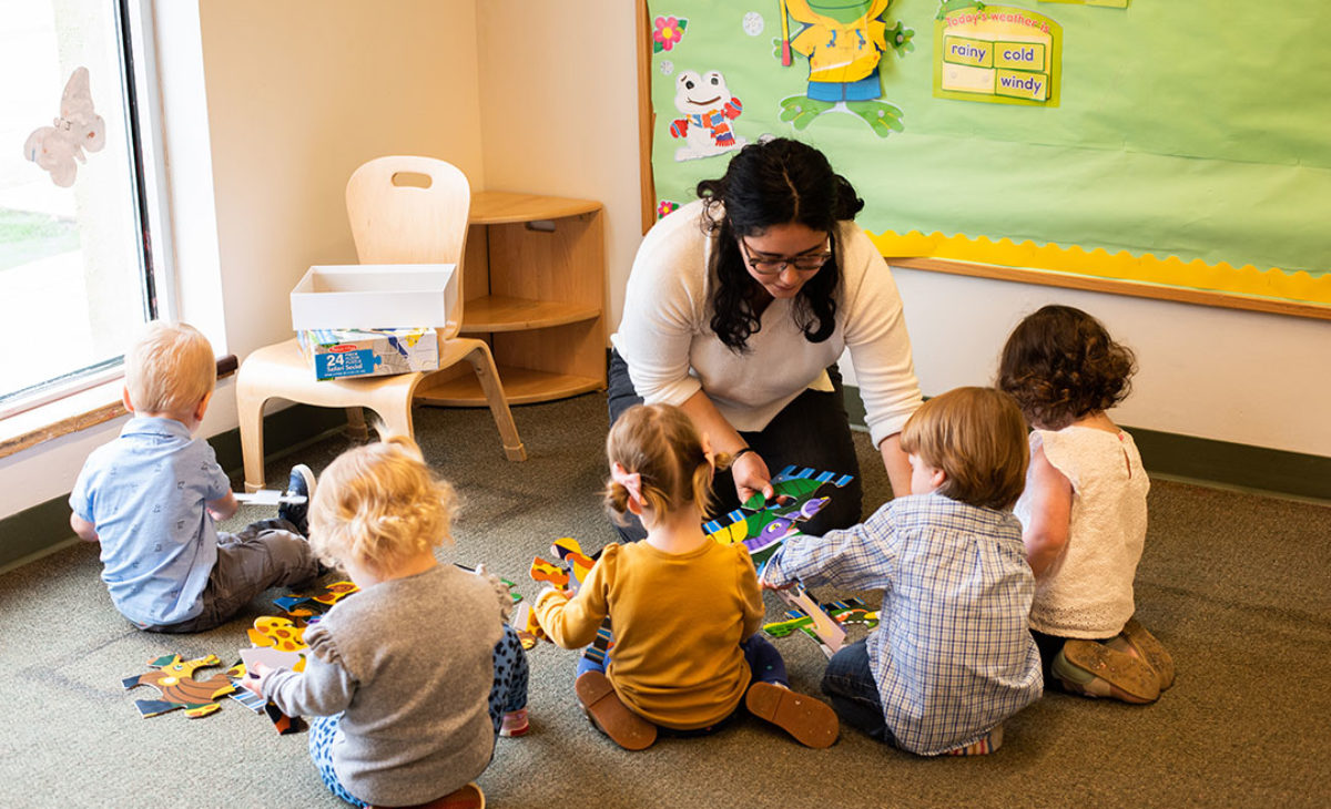 Lakeview teacher playing with group of toddlers