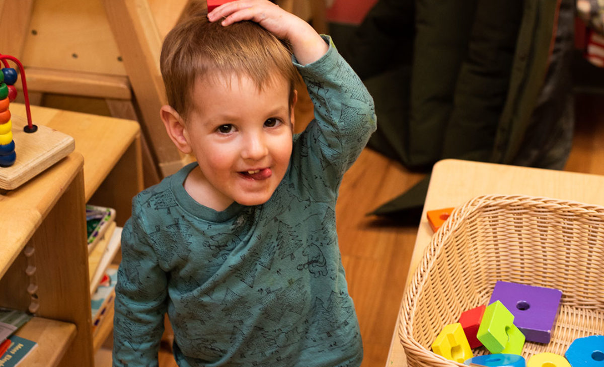 Little boy playing with building blocks