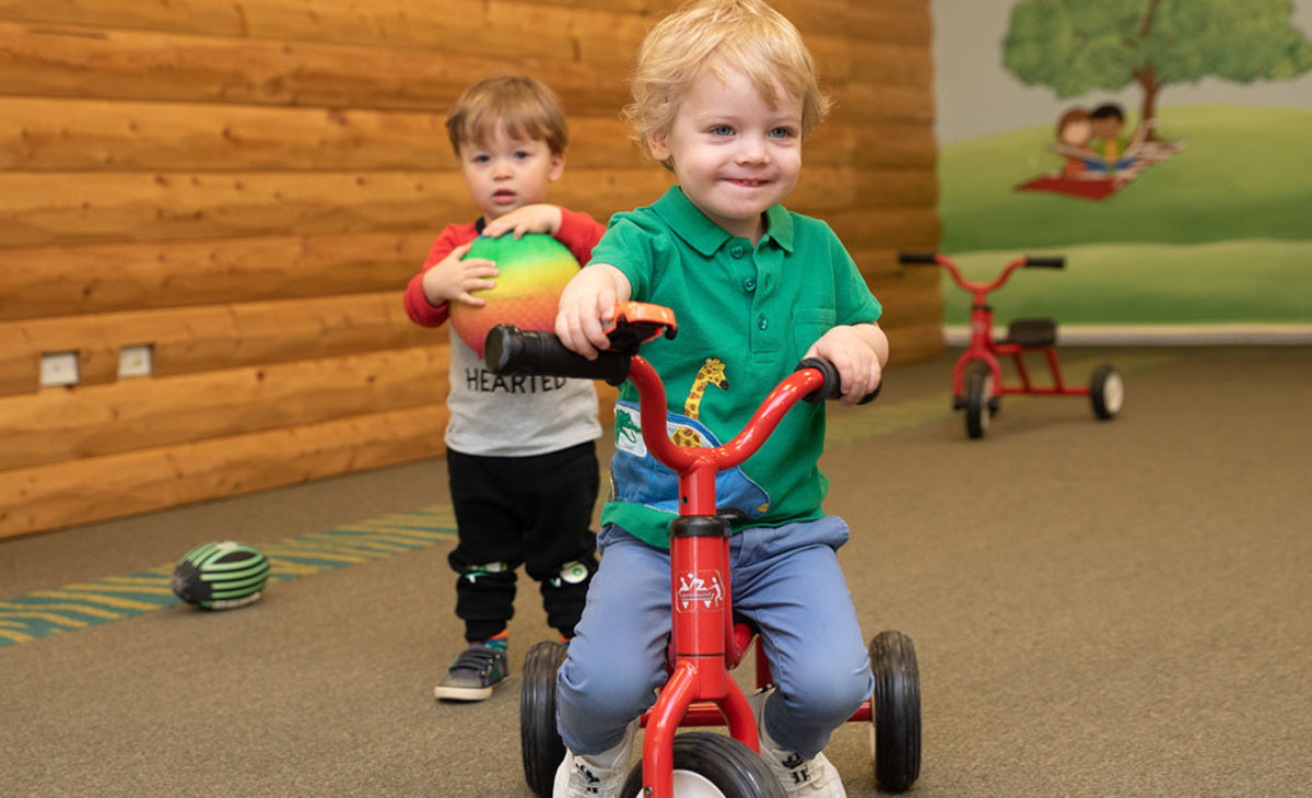 Toddler boy riding a tricycle