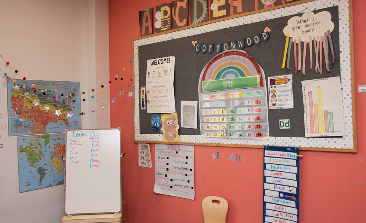 Bulletin board with calendar and student artwork