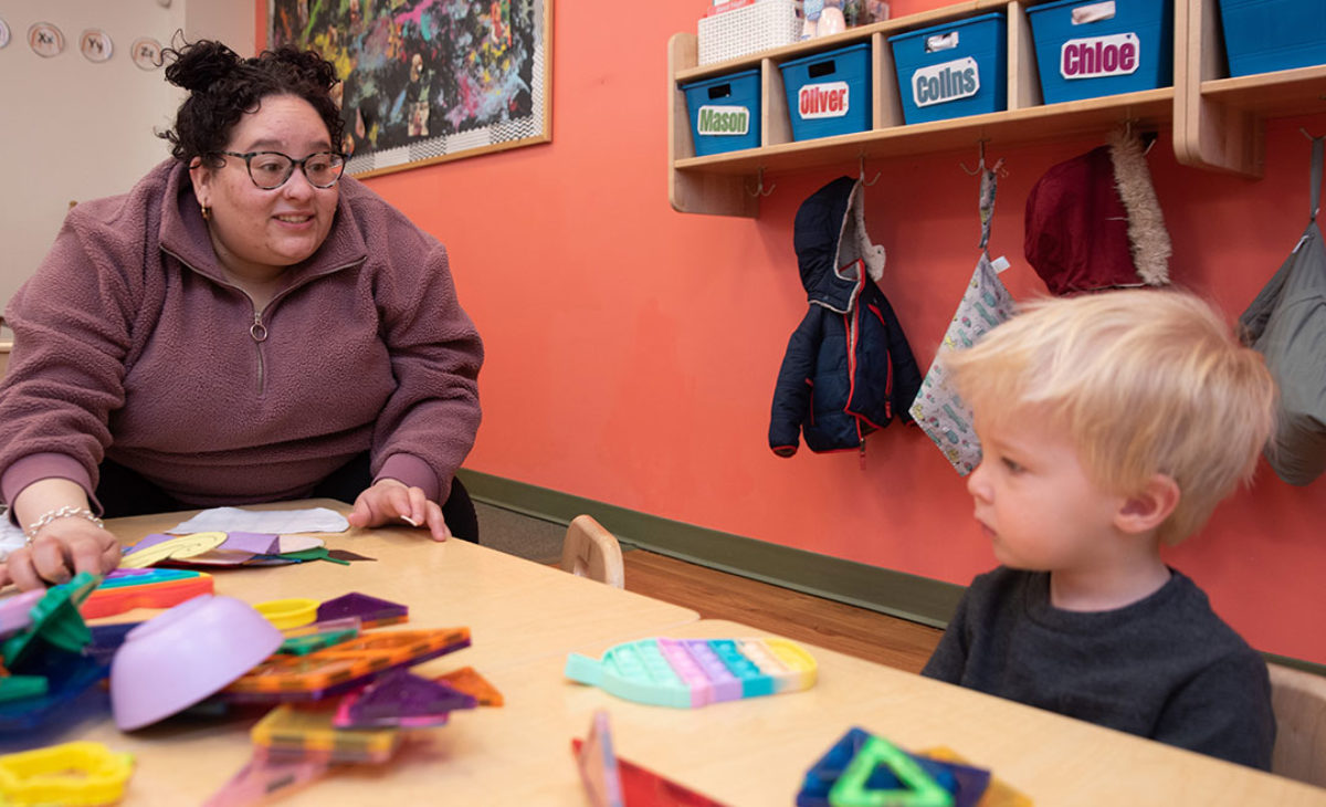 Teacher talks to a toddler during playtime