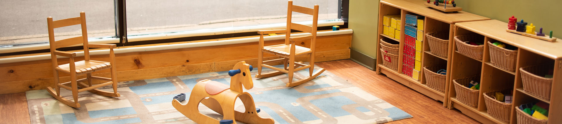 Daycare room with toddler's chairs and a rocking horse